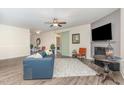 Comfortable living area boasts a fireplace, ceiling fan, and access to the dining area at 49 Parkside Dr, Lillington, NC 27546