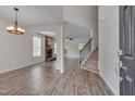 Bright living room featuring vinyl plank flooring, fireplace, and open to the dining room at 504 Applecross Dr, Mebane, NC 27302