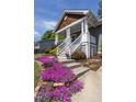 Close-up of the front steps adorned with vibrant flowers and meticulous landscaping at 507 Canal St, Durham, NC 27701