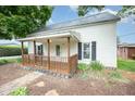 Charming home featuring a covered front porch with decorative wood railing at 510 May St, Gibsonville, NC 27249