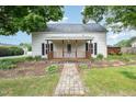 Charming home featuring a covered front porch with decorative wood railing at 510 May St, Gibsonville, NC 27249