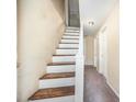 Hallway with painted stairway and carpeted floor at 510 May St, Gibsonville, NC 27249