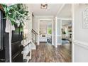Bright foyer featuring hardwood floors and views into the living spaces at 5172 Copain Cove, Fuquay Varina, NC 27526
