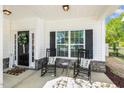 Inviting front porch with rocking chairs and decorative welcome mat at 5172 Copain Cove, Fuquay Varina, NC 27526