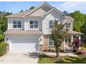 Beautiful two-story home with stone accents, a front porch, and meticulously maintained landscaping at 5240 Holly Ridge Farm Rd, Raleigh, NC 27616