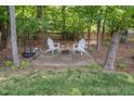 Secluded backyard patio with outdoor furniture and a fire pit, perfect for relaxing at 5610 Picnic Rock Ln, Raleigh, NC 27613