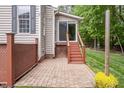 Cozy outdoor patio with brick flooring and string lights, ideal for entertaining at 5610 Picnic Rock Ln, Raleigh, NC 27613