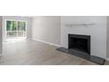 Spacious Living Room with fireplace and sliding glass door with access to outdoor deck at 567 Howard Tant Rd, Zebulon, NC 27597