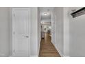 Hallway with natural wood floors and white trim, leading to the main living areas at 5701 Princess Curry Way, Raleigh, NC 27610