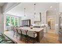 Open-concept kitchen with large island, stainless steel appliances, and a breakfast nook at 5803 Vintage Oak Ln, Raleigh, NC 27613