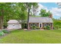 Charming brick home with a lush green lawn and a welcoming two-car garage at 615 Beaver Creek Rd, Apex, NC 27502