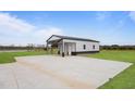 A versatile outbuilding with a concrete driveway, offering ample space for parking and storage at 6185 Nc-50, Benson, NC 27504