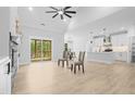 Spacious living room with hardwood floors, a fireplace, and a sliding glass door to the patio at 648 Shawnee Dr, Louisburg, NC 27549