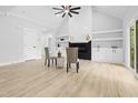 Bright and airy living room with a fireplace, built-in shelves, and hardwood floors at 648 Shawnee Dr, Louisburg, NC 27549