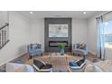 Cozy living room area with a modern fireplace, comfortable seating, and stylish decor elements at 76 Arlie Ln, Lillington, NC 27546