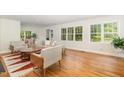 Bright living room featuring hardwood floors, neutral decor, and large windows that fill the space with natural light at 804 Old Mill Rd, Chapel Hill, NC 27514