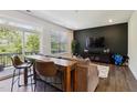 Modern living room boasts a cozy couch, sleek dark accent wall with TV, and patio view for a relaxing space at 805 Winter Meadow Dr, Wake Forest, NC 27587