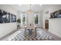 Bright dining room with modern lighting, decor, and a checkered area rug at 8237 Baronleigh Ln, Wake Forest, NC 27587