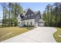 Attractive two-story home with a long driveway, attached garage, manicured lawn and mature trees at 8237 Baronleigh Ln, Wake Forest, NC 27587