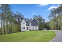 Beautiful exterior of a two-story home with a manicured lawn and mature trees at 8237 Baronleigh Ln, Wake Forest, NC 27587