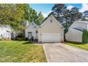 Inviting traditional home with a two-car garage, manicured lawn, and a classic architectural design at 8629 Swarthmore Dr, Raleigh, NC 27615