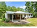 Charming home featuring a carport and brick foundation, nestled in a serene, green yard at 901D Gibson Rd, Mebane, NC 27302