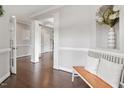 Bright foyer featuring hardwood floors, decorative columns, bench seating, and an open floor plan perfect for entertaining at 101 Jewell Farm Lane, Holly Springs, NC 27540