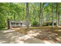 Home nestled among trees with a driveway and front yard, showcasing a serene setting at 104 Argyle Ct, Garner, NC 27529