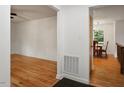 Open hallway showcases hardwood floors leading to the living room and dining area with natural light at 104 Argyle Ct, Garner, NC 27529