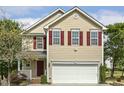 Charming two-story home with a well-manicured lawn, inviting entrance, and red shutters at 104 Caley Rd, Apex, NC 27502