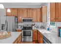 Well-equipped kitchen featuring stainless steel appliances, white countertops, and ample wooden cabinetry at 107 Candy Apple Ct, Cary, NC 27513