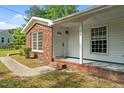 Charming house featuring a covered porch, classic brickwork, and well-maintained landscaping at 108 Deepwood Cir, Garner, NC 27529