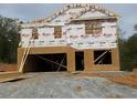 Image showing the framing stage of a new home's construction with wood and house wrap at 127 High Hampton Way, Fuquay Varina, NC 27526