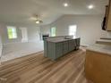 Open concept kitchen with an island, granite countertops, stainless appliances, and view to living area at 127 Oakfield Trace Dr, Four Oaks, NC 27524
