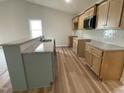 Well-equipped kitchen featuring granite countertops, and stainless steel microwave at 127 Oakfield Trace Dr, Four Oaks, NC 27524