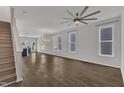 Spacious open-concept living area with hardwood floors and staircase access at 1272 Brown Velvet Ln, Apex, NC 27523