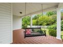 Relaxing porch swing on a spacious porch, perfect for enjoying the outdoor view at 140 Crystal Pl, Benson, NC 27504