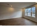 Well-lit living room with hardwood flooring, ample natural light, and neutral paint at 1569 Wendell Valley Blvd, Wendell, NC 27591
