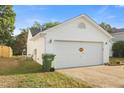 A spacious two-car garage is part of the exterior of this lovely home at 1725 E Honey Springs Ave, Fuquay Varina, NC 27526