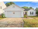 A well-maintained two-car garage and driveway are part of the appealing exterior of the home at 1725 E Honey Springs Ave, Fuquay Varina, NC 27526