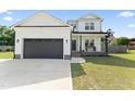 Charming two-story home featuring an attached garage and a covered porch with a rustic bench and American flag at 180 Packhouse Ct, Angier, NC 27501