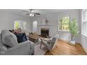 Bright living room with fireplace, hardwood floors, and large windows offering natural light at 1809 Glendale Ave, Durham, NC 27701