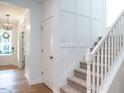 Bright foyer with staircase featuring white walls and hardwood floors at 200 Larkhaven Pl, Apex, NC 27539