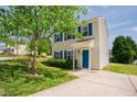 Two-story home featuring blue shutters and a quaint front entrance at 2032 Lime St, Durham, NC 27704
