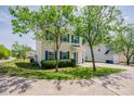 View of home with blue shutters and lush landscaping at 2032 Lime St, Durham, NC 27704