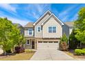 Attractive two-story home featuring neutral siding, stone accents, attached garage, and landscaped yard at 205 Begen St, Morrisville, NC 27560