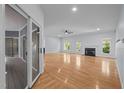 Spacious living room featuring hardwood floors, a fireplace, and large windows for ample natural light at 2123 Fountain Ridge Rd, Chapel Hill, NC 27517