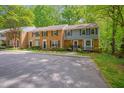 A partial view showing the exterior of a row of townhouses in a neighborhood with visible parking at 225 Bay Dr, Cary, NC 27511