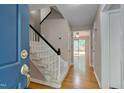 Bright foyer with hardwood floors, a carpeted staircase, and views into adjacent living spaces at 225 Bay Dr, Cary, NC 27511