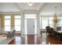 Elegant entryway featuring hardwood floors, natural light, and classic architectural columns at 2318 Carriage Oaks Dr, Raleigh, NC 27614